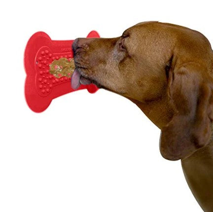 Red Lick Mat with brown dog licking Dawg Butter off of it