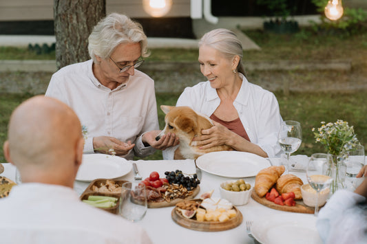 Family eating outside with their pet dog